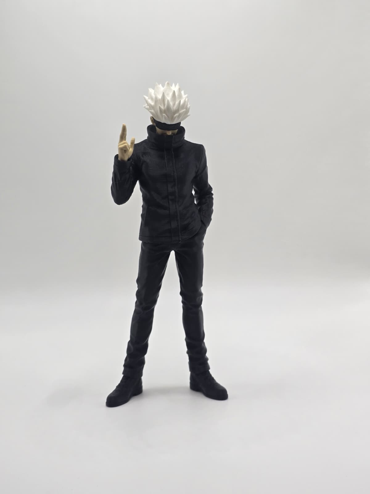 Figura impresa en 3D de cabello blanco y ropa negra sobre fondo blanco